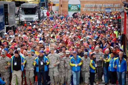 Volunteers holding back the runners at the start line